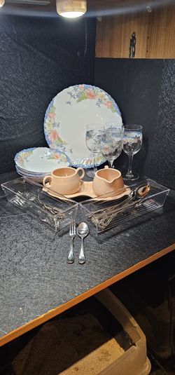 Plates, bowls, wine glasses & silverware.