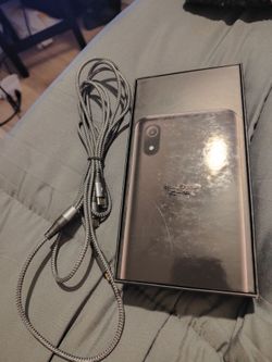 Selling new cell phone has new glass protector case extra long cord with 3-prong charger memory card and also extra SIM card