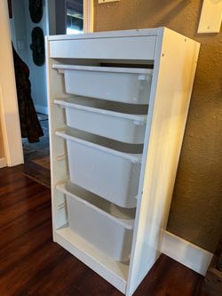 White storage cabinet with bins