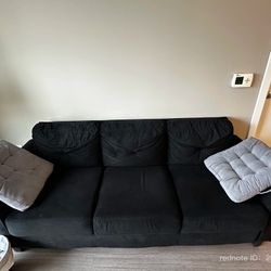 three-seater black sofa