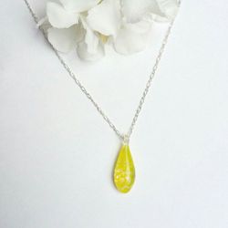Necklace with handblown glass teardrop pendant with painted yellow swirls on a silver colored chain