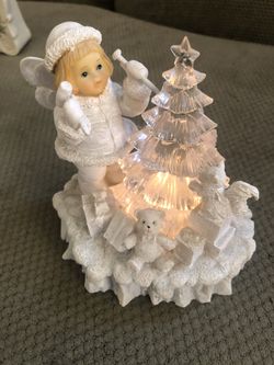 Beautiful Angel Trimming A Crystal Tree Light