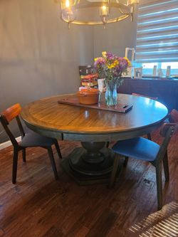 Round walnut table seats 6 with 4 chairs available