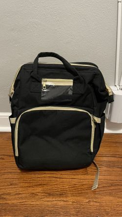 Diaper bag with changing station