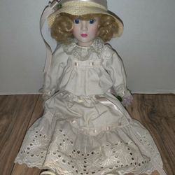Vintage Victorian Style Cloth & Porcelain Doll 16'in With Hat & Blue Eyes. Dolls has some stains and wear from age and storage. Sold as is.

