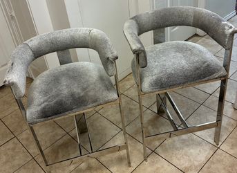 2 Interlude Darcy Counter Stools Featuring Natural Hide Seats And Stainless Steel Frames In Polished Finish