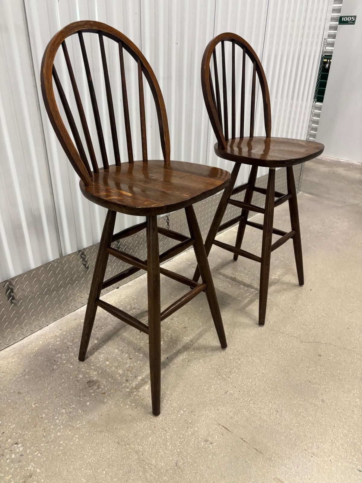 Two solid wood vintage bar stools , both swivel..,