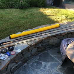 THREE FLY RODS WITH REEL PLUS A COLUMBIA FLY VEST WITH FLY CASE & FLIES.