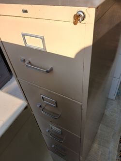 Beige file cabinet Has key 4 drawer metal