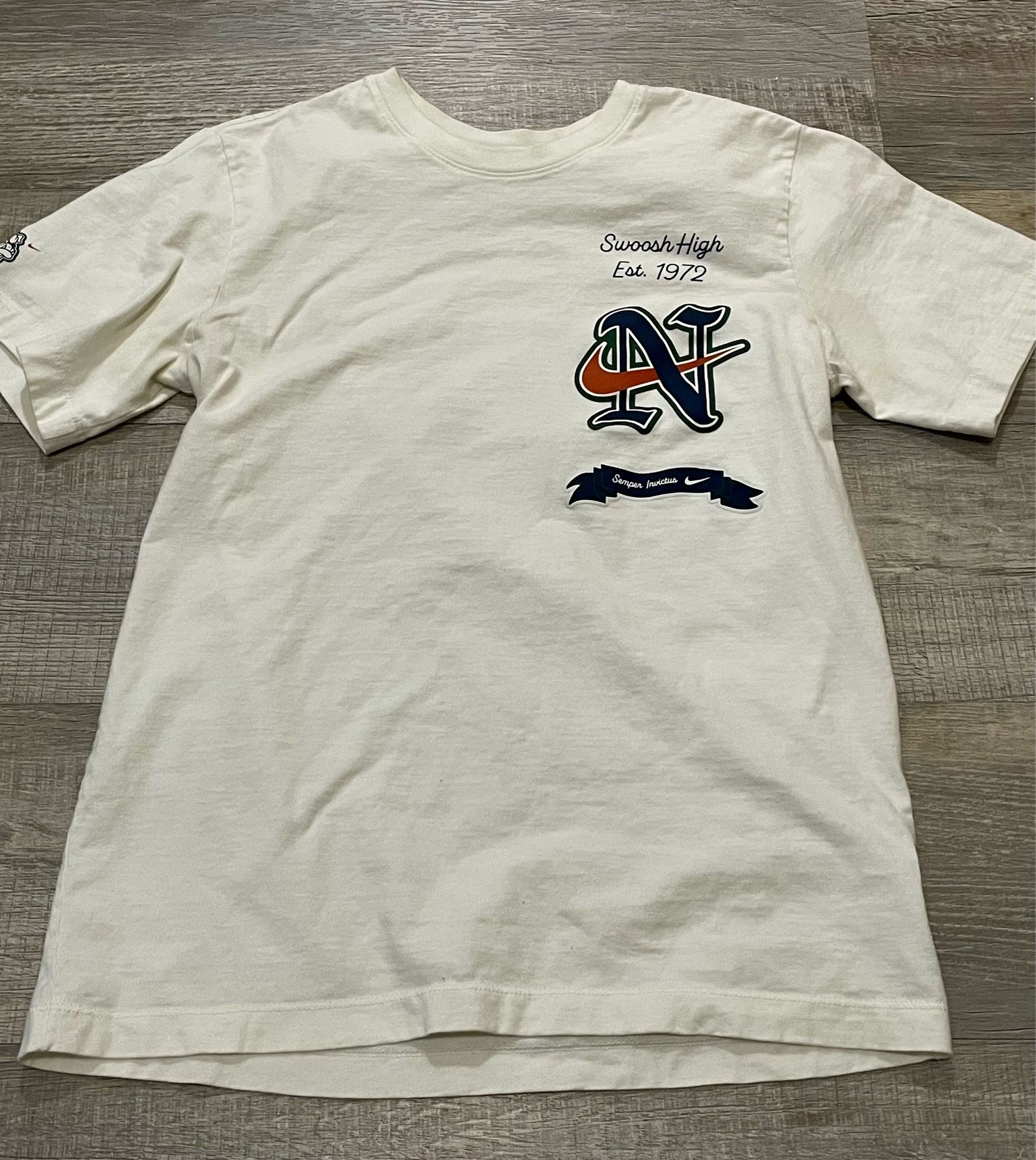 Nike Sportswear "Swoosh High" graphic t-shirt featuring varsity-style small tee