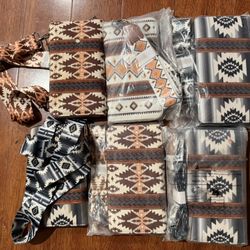 6/2 This tribal-style printed wallet features a full-length zipper, a wide wrist strap, and a shoulder strap for added security.