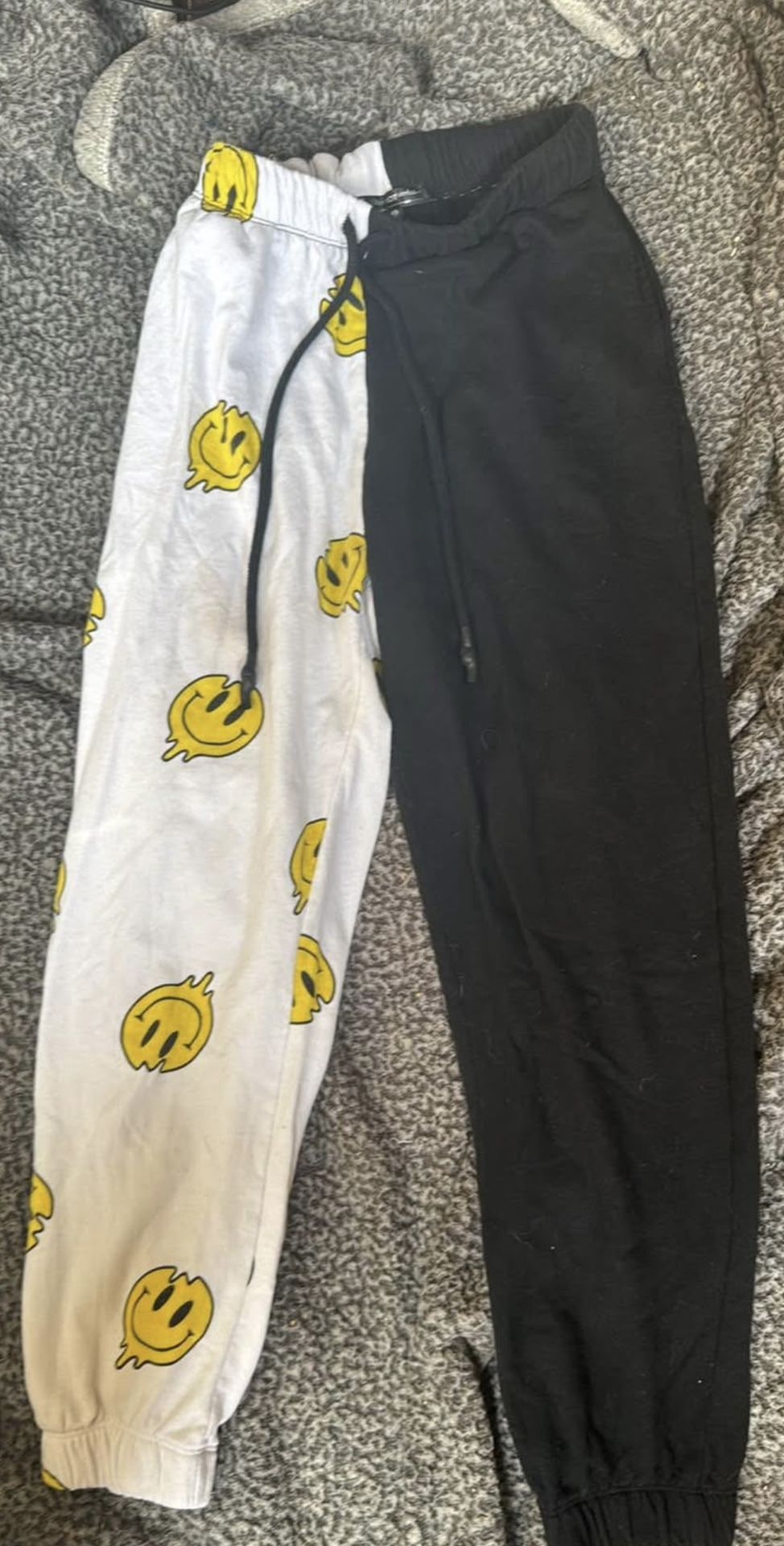 half smiley half black sweatpants