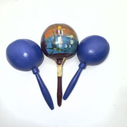 This product is a set of three hand-painted maracas made in Mexico. The maracas are made of lightweight wood and have a diameter of 7 inches. The set 