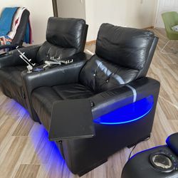 Home Theater reclining chairs black leather with table/tray, with blue lights. 