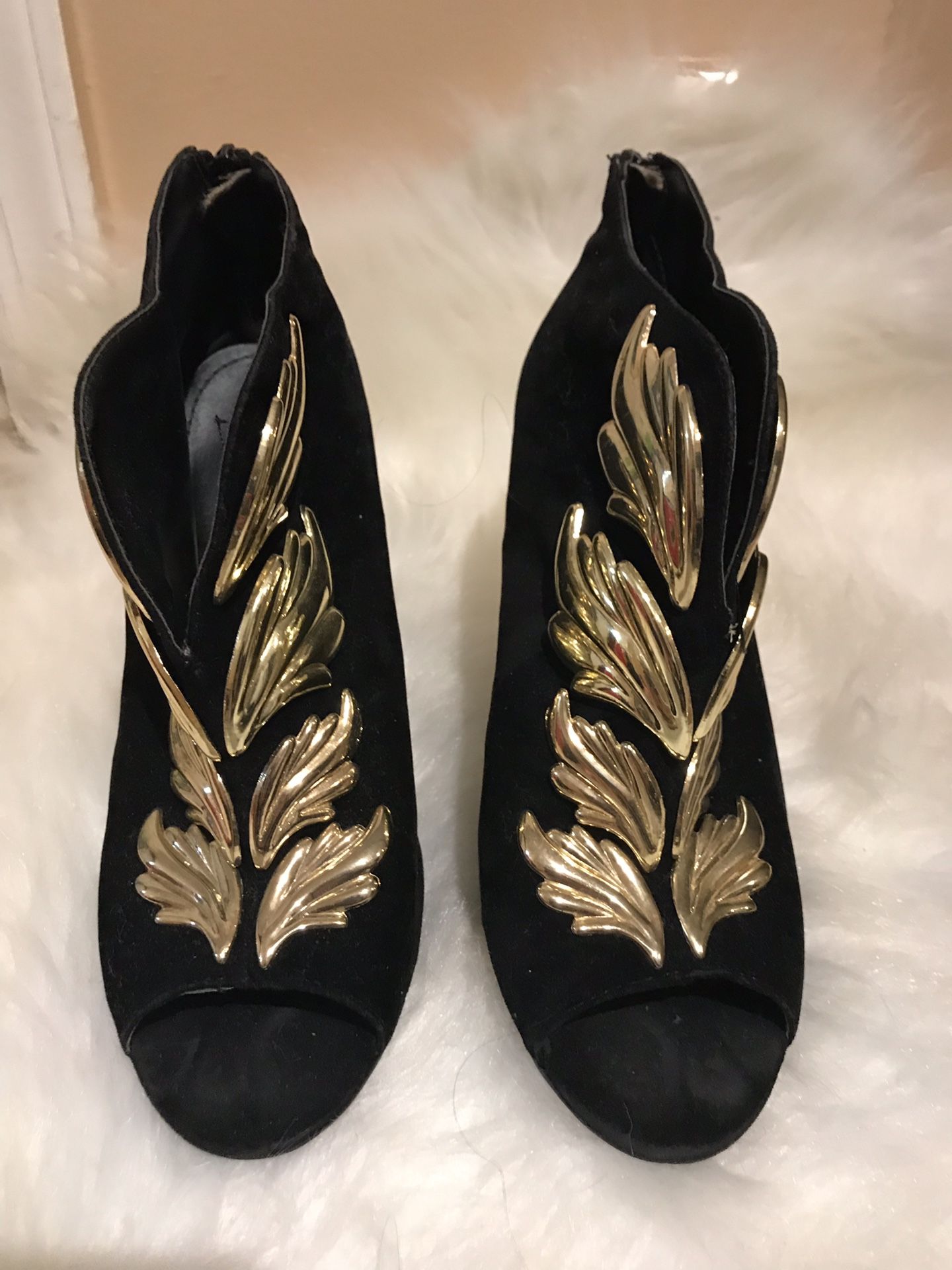 Black velvet booties with gold accent embellishment