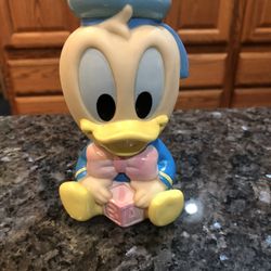 Vintage Disney Baby Donald Duck Soft Rubber Squeaky Toy with a block. Size 4 1/2 inches tall. Preowned. Nice edition to any Disney Donald Duck coll