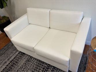 White faux leather love seat