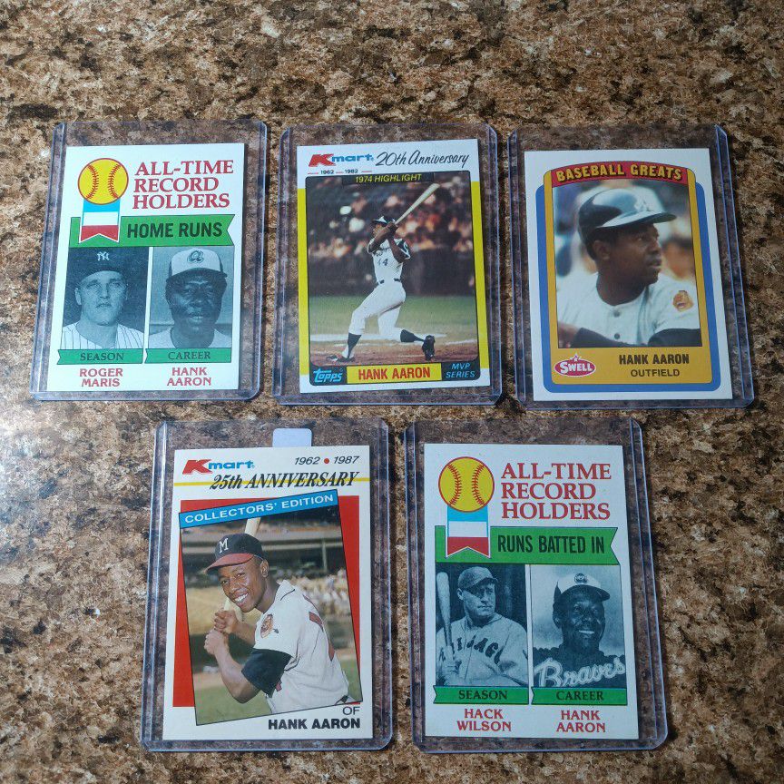 Five Hank Aaron Baseball Cards.