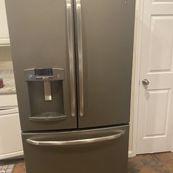 Aide By Side GE Refrigerator 