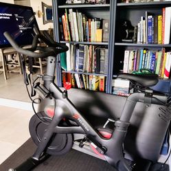 Peloton Bike – Like New! Only 11 Hrs + Mat, Weights & Shoes 