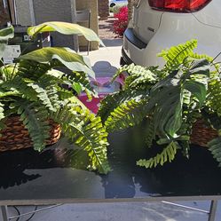 Two baskets of fake plant arrangements