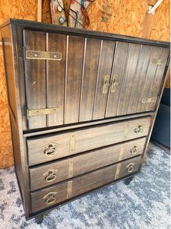 vintage Furniture dresser featuring wood construction with brass hardware accents
