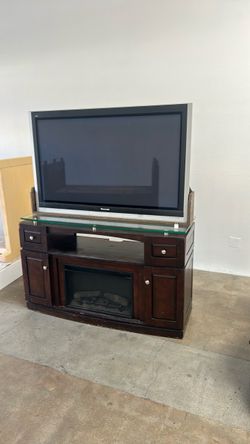 TV with functional fireplace console and arm chair recliner