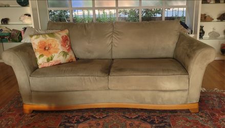 2 sage green, microfiber couches with wood frames.