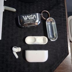 Left Air Pod Pro with charging case and plastic NASA case.