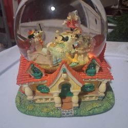 Disney mickey Mouse and friends musical snow globe featuring a house base.
