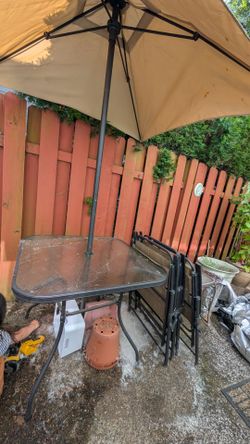 Patio table, 4 folding chairs, umbrella