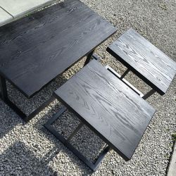 dark brown black end tables and coffee table with a black metal base.