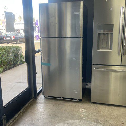Stainless steel Frigidaire refrigerator with top freezer