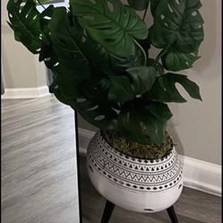 Faux fake monstera plant and metal planter with legs