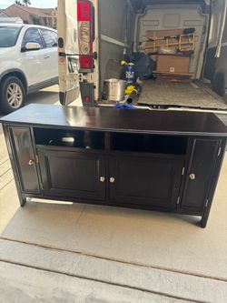 Black Wood TV Stand with Cabinet Storage has small chip out the back leg solid $30 obo