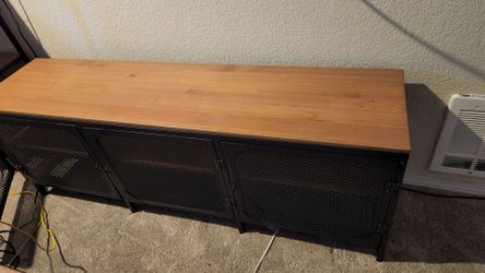 Ikea brand shelving with iron grate doors.