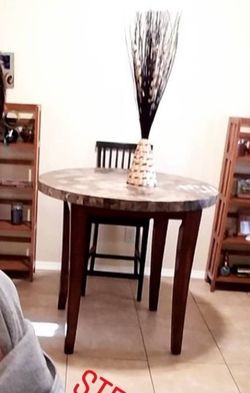 Granite topped bar height table with 4 chairs