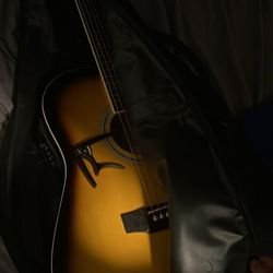 Acoustic guitar and capo and guitar bag 