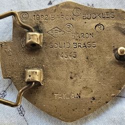Vintage 1982 Baron Motorcycles Solid Brass Nameplate Belt Buckle, identified as model MG03156. 
This buckle is characterized by: 
Maker: Baron Buckles