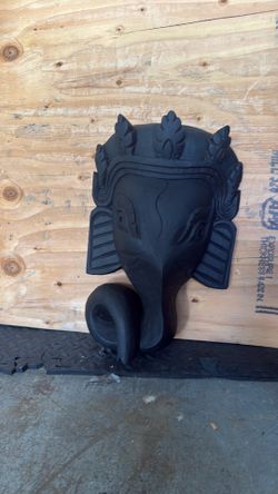 decorative wall hanging is a hand-carved wooden Ganesha mask,