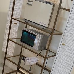 gold and glass shelving unit.
