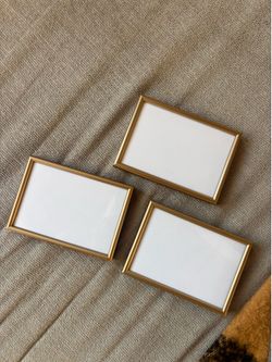 Three 3.5”x5” gold picture frames