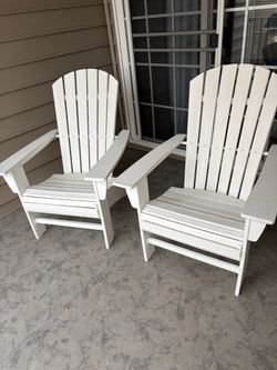 Two Polywood Adirondack chairs.