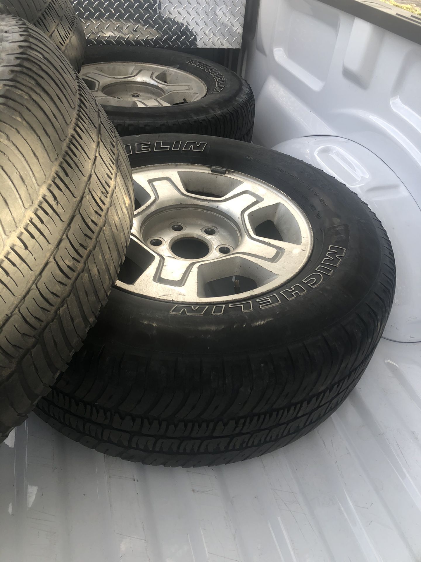 4 rims and tires -used Chevy hub cap covers and lug nuts included