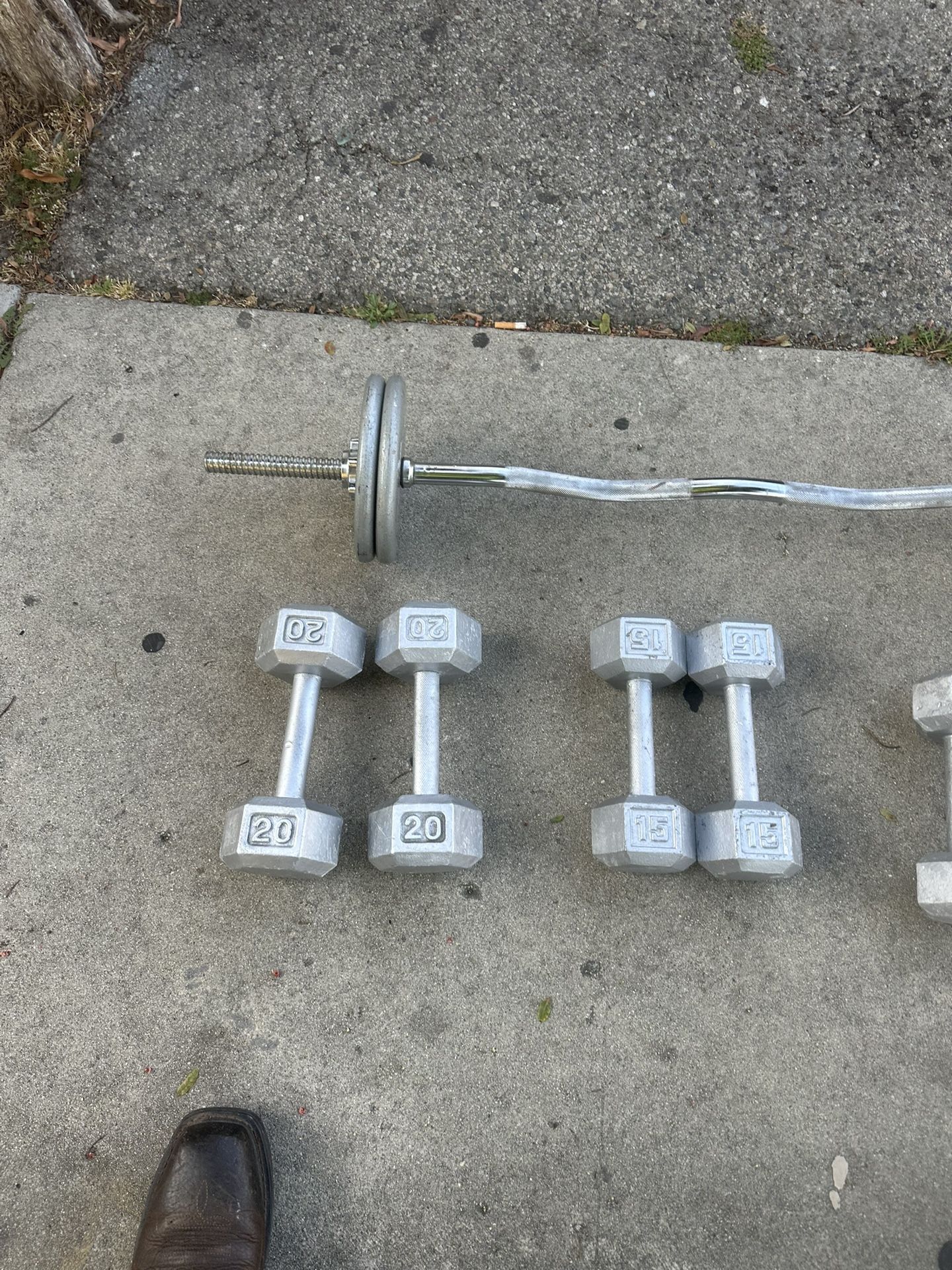 One Set Of 20lbs, One Set Of 15lbs, One Set Of 12lbs, And 40lb Weight Plates With Bar