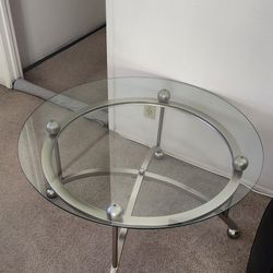 Glass Coffee Table With Stainless Steel Base..