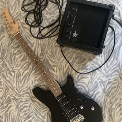 Electric guitar with speaker and cords