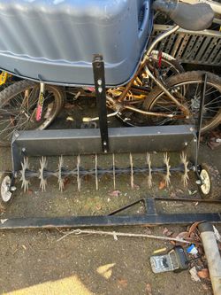 Compact tow behind aerator/spreader