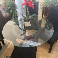 Very Nice And Clean Set Of Table With Round Glass Top And It’s Matching 4 Upholstered Black Seats With Pretty Design On Them. It’s In Great Shape.  
