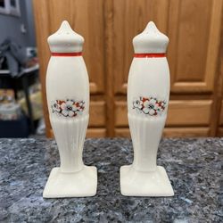 Vintage Ceramic 1950’s Tall Floral Pair of Salt and Pepper Shakers.  Size approximately 5 inches tall.  Preowned.  Has been on display in a cabinet wi